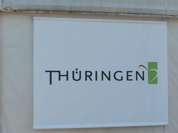 White Thüringen logo banner hanging on an outdoor tent