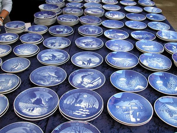 Blue Royal Copenhagen porcelain plates displayed on a market stall