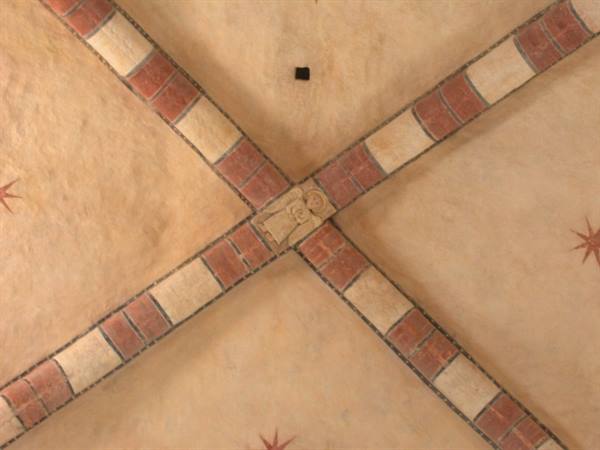 Stone and red brick cross vaults with carved keystone