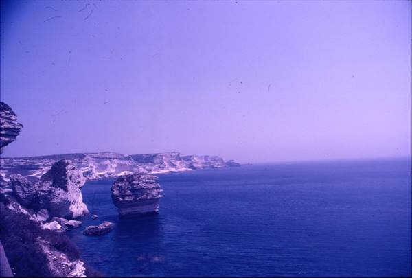 white limestone cliffs and sea stack above blue water at Bonifacio