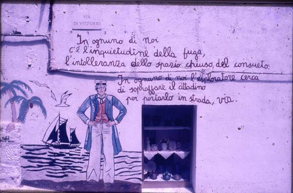 Mural with poetic writing and painted sailor beside a doorway