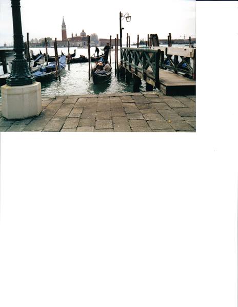 Gondolas moored at a wooden pier, San Giorgio Maggiore in the background, Venice