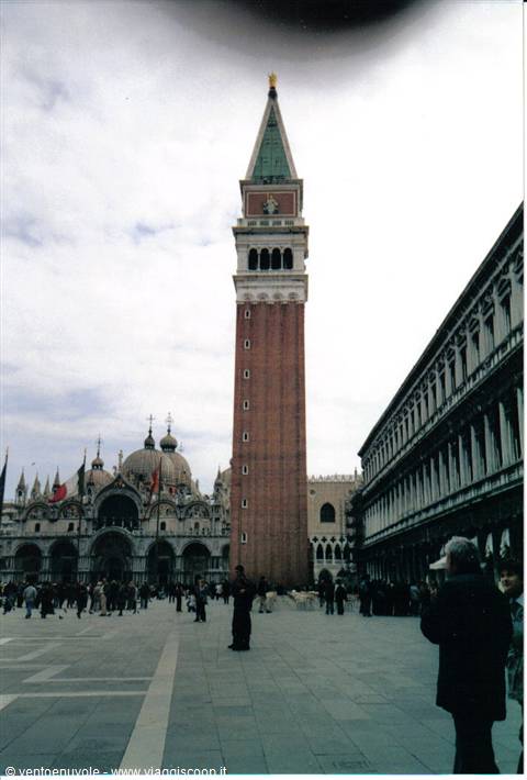 St Mark's Campanile in Venice with tourists walking on the square