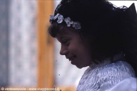 Smiling girl wearing white flower crown and light dress