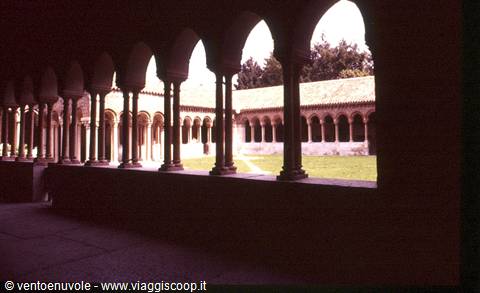 Romanesque cloister with paired columns and arches overlooking the inner garden