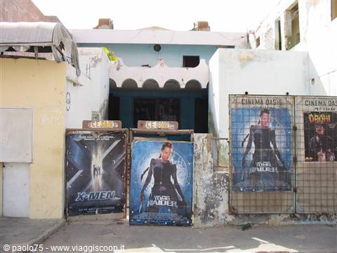 Weathered Cinema Oasis, faded X-Men and Tomb Raider posters by the entrance