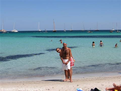 Couple on white sand, turquoise sea at Isla de Tabarca