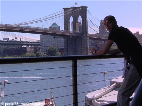Tourist on ferry in front of Brooklyn Bridge, New York