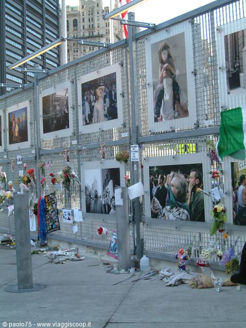 Fence covered with memorial photos and flowers at Ground Zero, New York