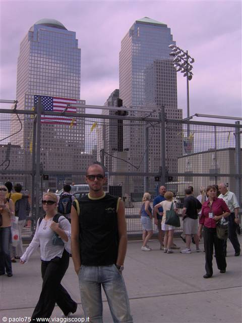 Tourist standing before the Ground Zero fences with towers behind