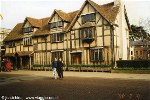 Couple walking past Shakespeare's half-timbered birthplace in Stratford-upon-Avon