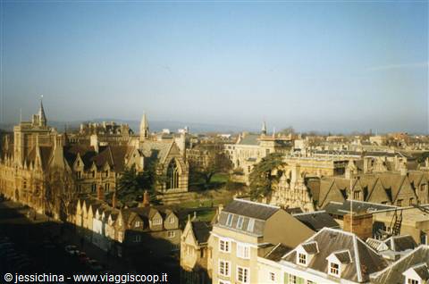 Stone rooftops and Gothic spires of Oxford under a blue sky