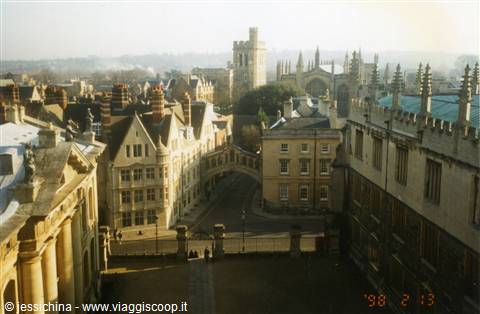 Oxford's Bridge of Sighs between pale stone buildings, warm morning light