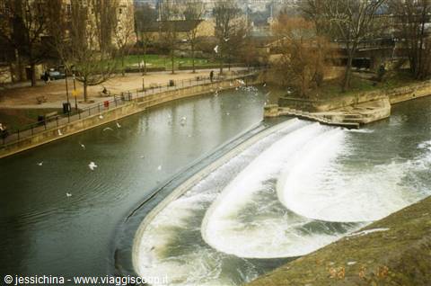 Pulteney Weir's curved weir on the River Avon in Bath, seagulls flying