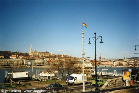 Budapest: Hungarian flag on pole, Danube river with docks and traffic