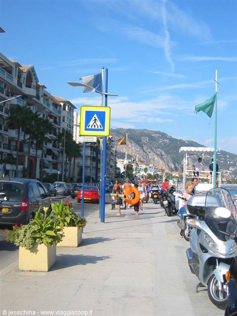 Beachfront promenade with scooters and pedestrians