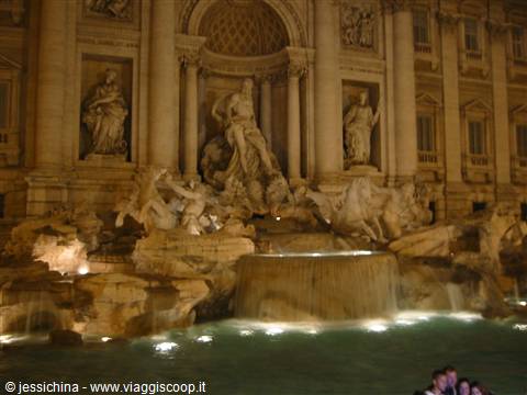Trevi Fountain at night, illuminated marble statues and flowing water