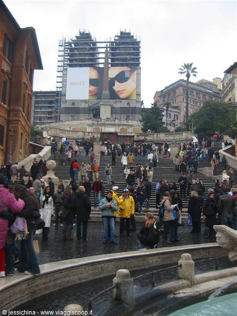 Crowds on the Spanish Steps in Rome, scaffolding above, grey sky