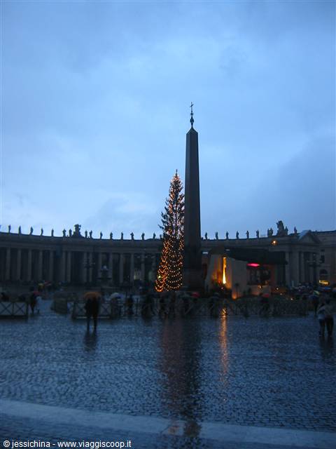 St. Peter's Square in the rain: Egyptian obelisk and lit Christmas tree