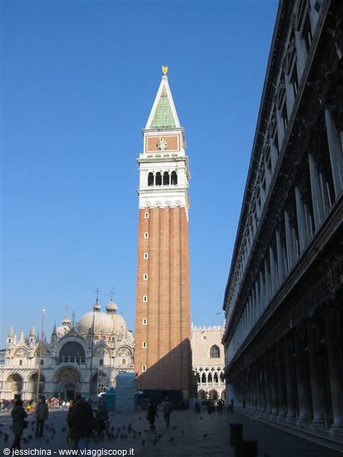 St Mark's brick bell tower beside the arcades, tourists and pigeons on the square