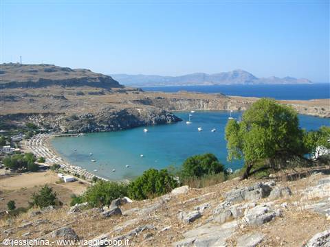 Lindos bay: white boats anchored in turquoise water between arid hills