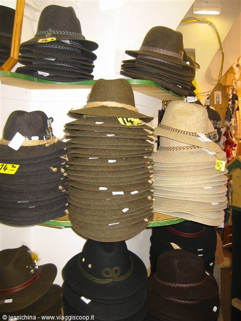 Stacks of brown and beige felt alpine hats piled on shop shelves