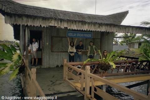 Tourists greet on the wooden walkway of D'Millian Dream Paradise, stilt house over water