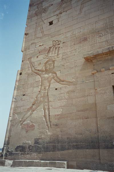 Carved stone relief of a smiting pharaoh at Philae temple