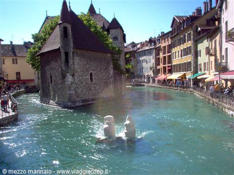 Palais de l'Isle on the canal in Annecy, colorful houses and swans