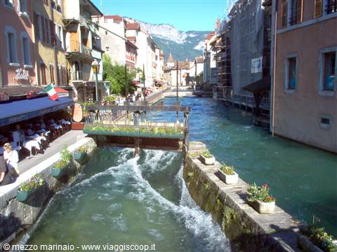 Small weir on a canal between colorful buildings, Annecy