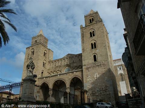 Cefalù Cathedral, stone facade with two Norman towers under cloudy sky