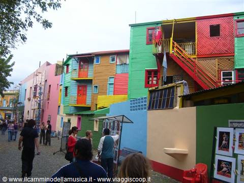 Colorful sheet-metal houses on Caminito street, La Boca, tourists strolling by