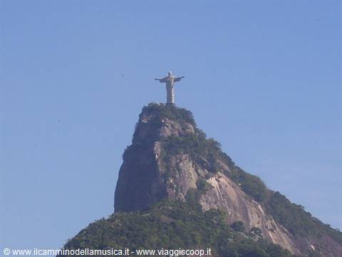 Christ the Redeemer statue with open arms atop Corcovado granite peak