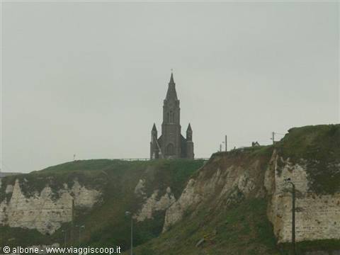 Notre-Dame de la Garde chapel on the Étretat cliff under a grey sky