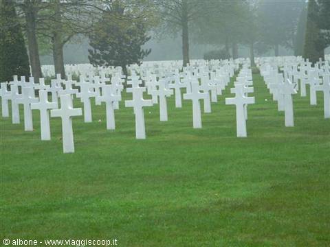 Rows of white crosses at the American cemetery in fog