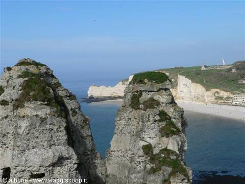 Etretat cliffs, weathered limestone rock stacks overlooking the sandy beach