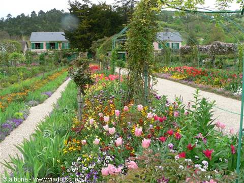 Flowerbeds with tulips and green arches in Monet's gardens at Giverny