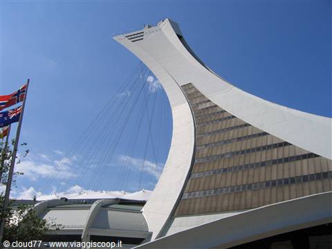 The inclined tower of Montreal Olympic Stadium against a blue sky