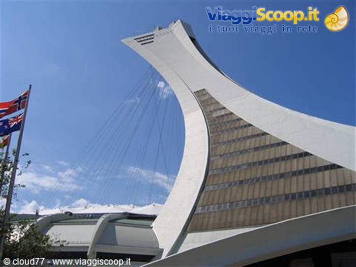 The inclined tower of Montreal Olympic Stadium against a blue sky