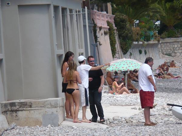 Beachgoers chatting on the pebble beach in Nice