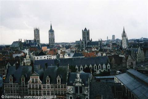 Medieval towers and rooftops of Ghent under grey sky, Flemish brick houses