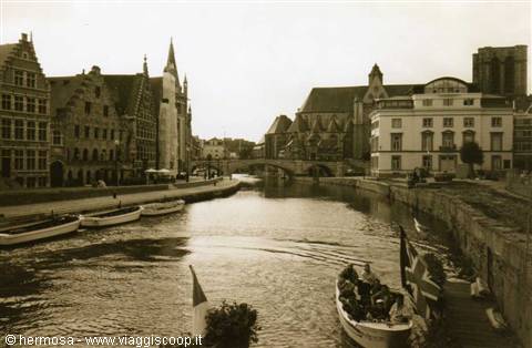 Tour boats on Ghent canal among medieval brick houses