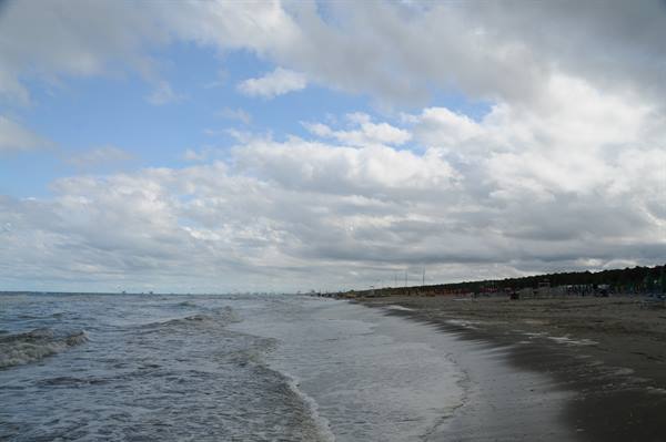 Waves on the sandy beach under a cloudy sky