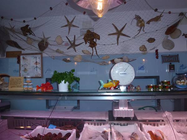 Fish shop counter with scale, fishing net and starfish on the ceiling