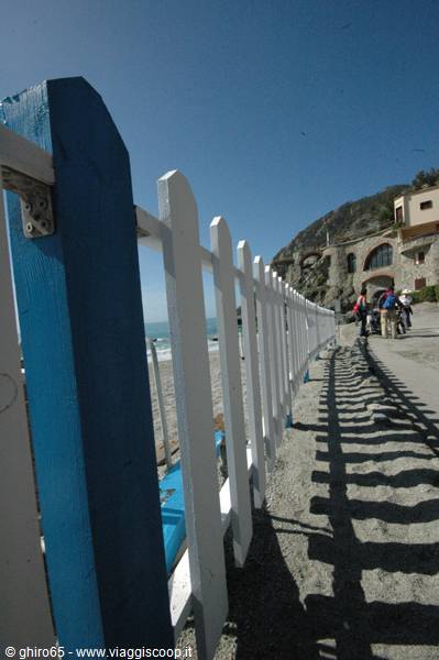 White and blue wooden fence along Monterosso sunny beach