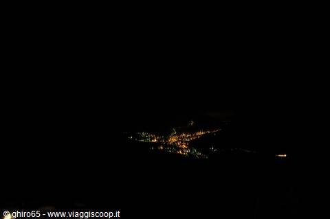 Village lights scattered in the darkness of a mountain night