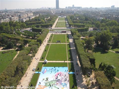 Champ de Mars seen from the Eiffel Tower, green avenue with strollers and distant skyscraper