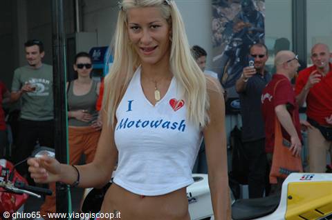 Blonde woman in Motowash tank top among the crowd at a motorcycle event