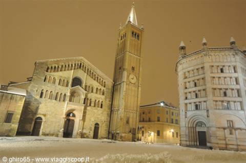 Parma Cathedral and Baptistery under snow at night, amber light