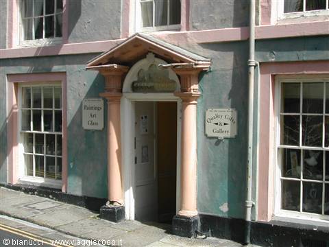 Pink-columned entrance of Chaffey & Sons art gallery on a green facade